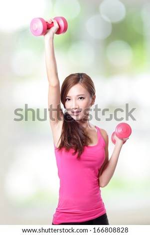 Young sport girl with dumbbells with green background, asian