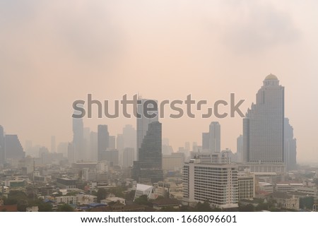 Unhealthy air pollution in Bangkok city business district, pollute with PM 2.5 dust, smog or haze, low visibility Royalty-Free Stock Photo #1668096601