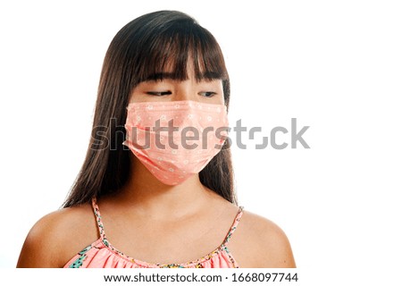 Asian girl wearing mask and protecting herself from viruses