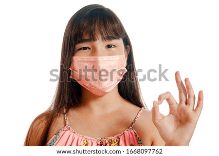 Asian girl wearing mask and protecting herself from viruses