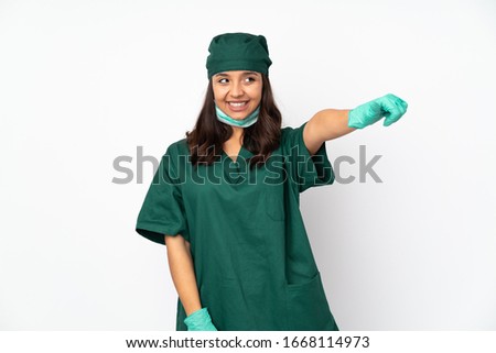 Surgeon woman in green uniform isolated on white background giving a thumbs up gesture