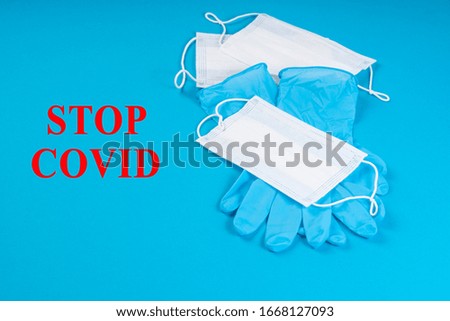 Stop coronavirus warning sign.Medical blue gloves with white respiratory masks on a blue background with text.Healthcare and coronavirus, quarantine and deficiency of personal protection.