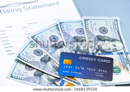 top view picture of medical billing statement,  banknotes and credit card on the gray background. health record, insurance and healthcare concept