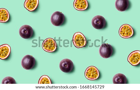 Colorful fruit pattern of fresh passion fruits on green pastel background, top view Royalty-Free Stock Photo #1668145729