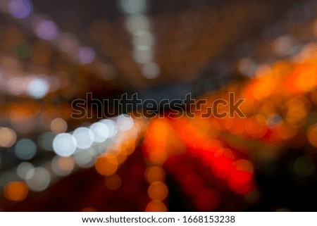 The abstract bokeh of the animated night in the street depicts the lively and beautiful nightlife.