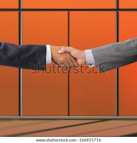 Business people handshaking on background of modern office