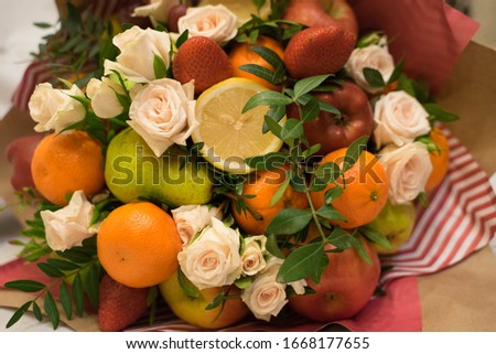 fruit and berry bouquet with roses in a package Royalty-Free Stock Photo #1668177655