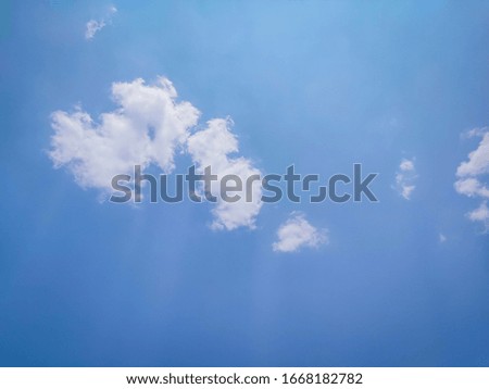 Clear sky and 1 cloud with light penetrating through the lines