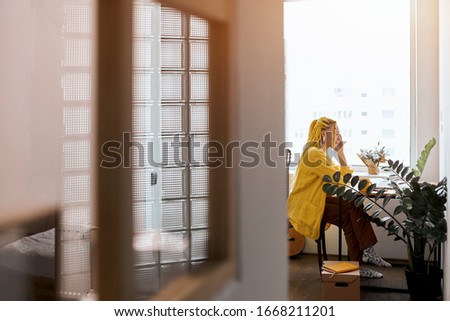 woman concentrated on preparing for a meeting, full length side view photo, copy space , girl working as a shop assistant in online shop, girl reading, searching news , information form the net.