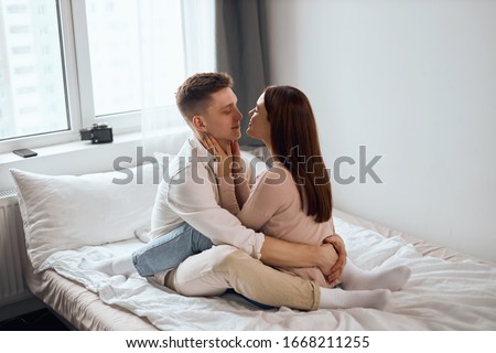 young beautiful woman closing her eyes touching her boyfriend neck, hugging him, happiness, enjoyment. side view full length photo.sexuality.Happy strong marriage Royalty-Free Stock Photo #1668211255