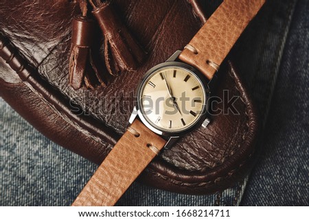 Vintage wristwatch with luxury italian leather strap and brown trendy oxford shoes. Classic timepiece mechanical watch, Men fashion and accessories. Royalty-Free Stock Photo #1668214711