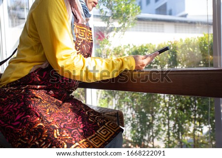 business owner young  25s Muslim woman wearing hijab working with  payments app smartphone, E-commerce, e-bank, a credit card makes a payment, pay online, shopping order, a woman paying online

