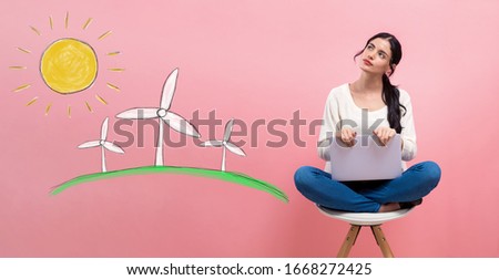 Windmills with young woman using a laptop computer