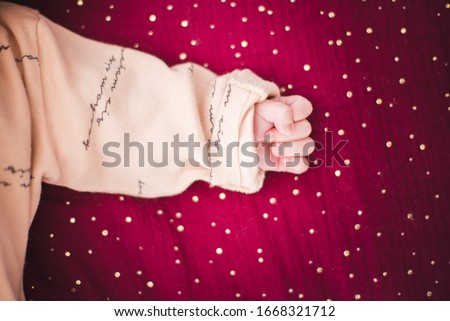 Baby hand with a red background