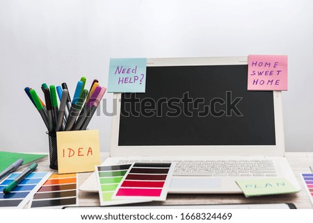  laptop with designer color swatches on the working place.