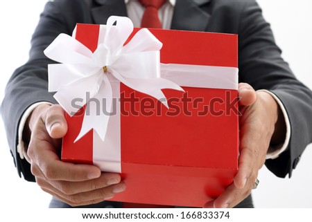 Businessman holds  the red gift box