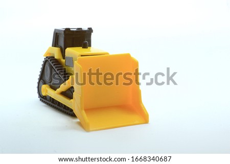 yellow plastic bulldozer toys as a medium to introduce construction tools to children. as thrust and can also be used as a destroyer. besides construction, it can also be used in mining companies
