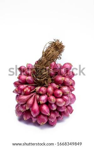 Bunch of high quality small red shallot sambar onions from India isolated