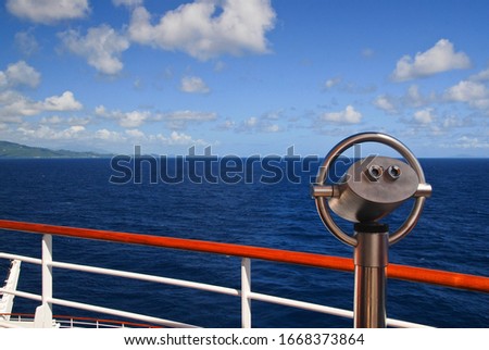 Binocular of a cruise ship in the Caribbean, blue sky with some clouds