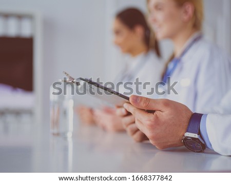 Doctors at the meeting, sitting on the desk