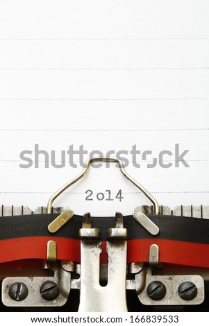 White paper with 2014 year typed on mechanical machine and writing paper