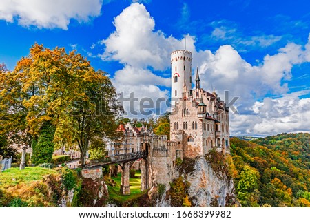 Germany, Lichtenstein Castle in Baden-Wurttemberg land in Swabian Alps. Seasonal view of Lichtenstein Castle on a cliff circled by trees with yellow foliage. European famous landmark.