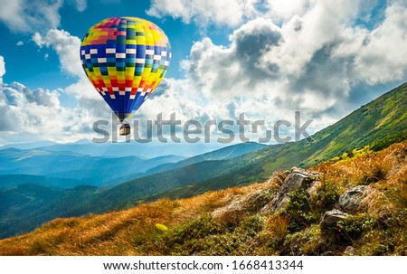 Amazing view of mountains with colorful hot air balloon. Travel concept. Artistic picture. Beauty world.