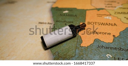 A bottle of red wine on a map of Namibia.