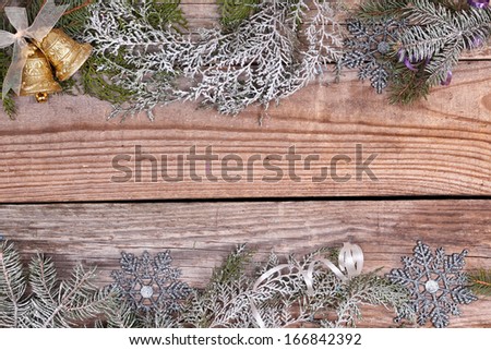 Christmas evergreen branches frame with christmas decoration on the wooden background