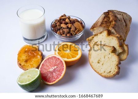 Homemade brad, almonds, milk, fruits on white background. Healthy breakfast. 