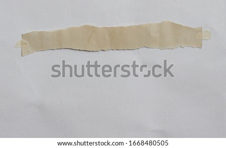 old torn paper with adhesive tape on white background.