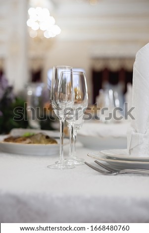 Wine glasses and glasses on the server table.Luxurious elegant dinner at the table in the restaurant. Holiday table decoration