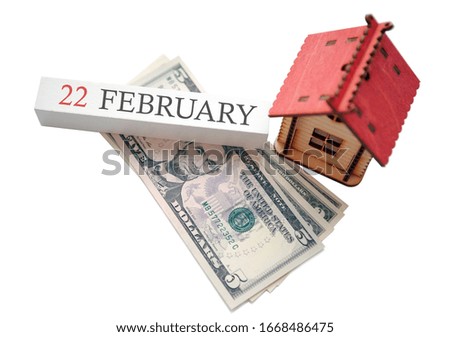 Money, home and calendar. The concept of financial independence and the scheduled start date for February 22