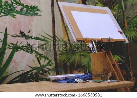 paintbrush with blank painting paper as copy space for mock up in the gaden