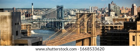 Morning mist on the East river under the Manhattan and Brooklyn Bridges in New York City USA