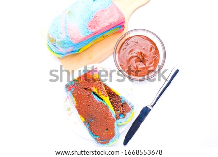Flatlay picture of bengali slice bread with chocolate spread on white background and copy space.