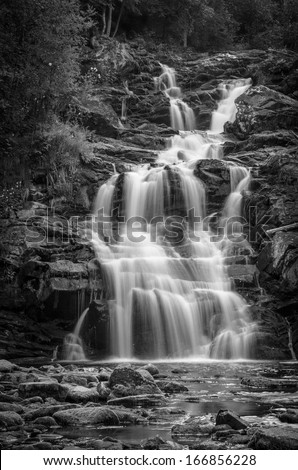 black and white shot of high waterfall