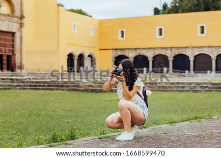 mexican girl with camara, Female photographer taking pictures on South America in vacations