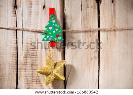 At the wooden board with pegs pinned Christmas ornament.