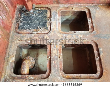 cargo hold bilge wells on bulk carrier after cleaning and preparing to list next cargo as per charter party. these wells will collect water from cargo and can be pumped out to prevent the damage. Royalty-Free Stock Photo #1668616369