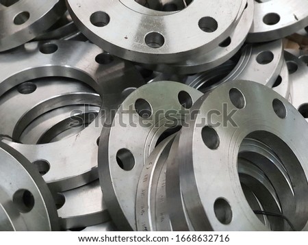 Stacks of various sizes of small flange welded,Flat Face Flange. Royalty-Free Stock Photo #1668632716