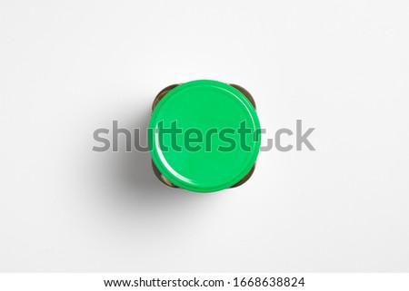 Glass jar with Pickled Cucumbers on white background with blank label.Marinated cucumbers in mason jar.High resolution photo.