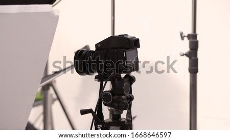 Studio medium format digital camera setup on tripod and professional equipment in studio with black and white color softbox and lighting set for still photo shooting or high resolution video or movie