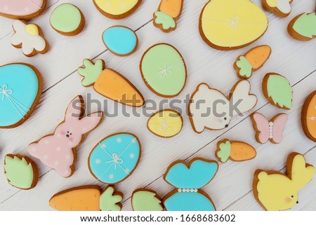 Easter card with gingerbread cookies. Egg shaped cookies and easter bunny. Happy easter holiday background concept. Flat lay.