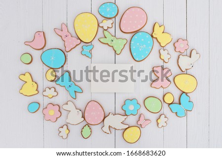 Easter card with gingerbread cookies. Easter card template. Egg shaped cookies and easter bunny. Happy easter holiday background concept. Flat lay. Copy space.