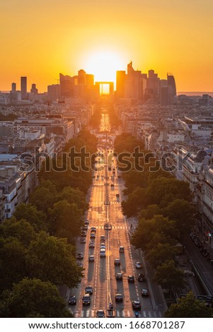 This is a sunset photo taken at the Arc de Triomphe in Paris, France.