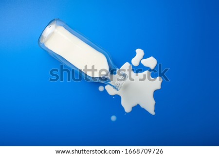 bad milk lactose intolerance allergy. milk bottle splatter. avoid dangerous dairy Royalty-Free Stock Photo #1668709726