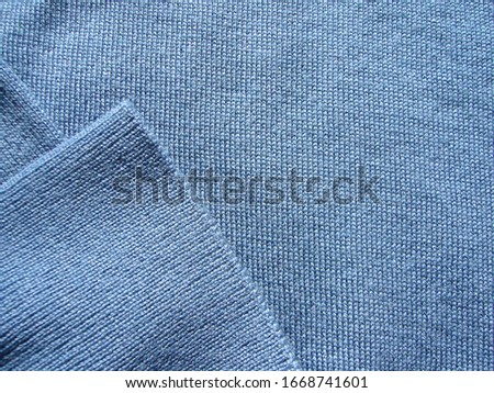The texture of the fabric. Light blue merino wool knit fabric.