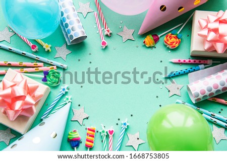 Happy birthday or party background.  Flat Lay wtih birthday balloons , confetti and ribbons on pastel green background. Top View.  Copy space. Royalty-Free Stock Photo #1668753805
