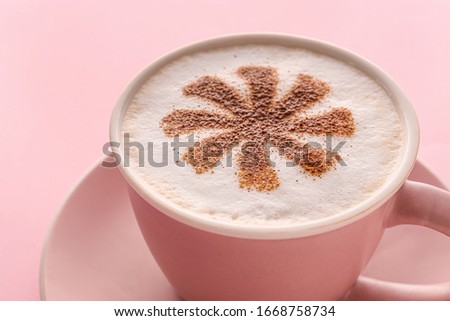 Cup of tasty cappuccino on color background, closeup